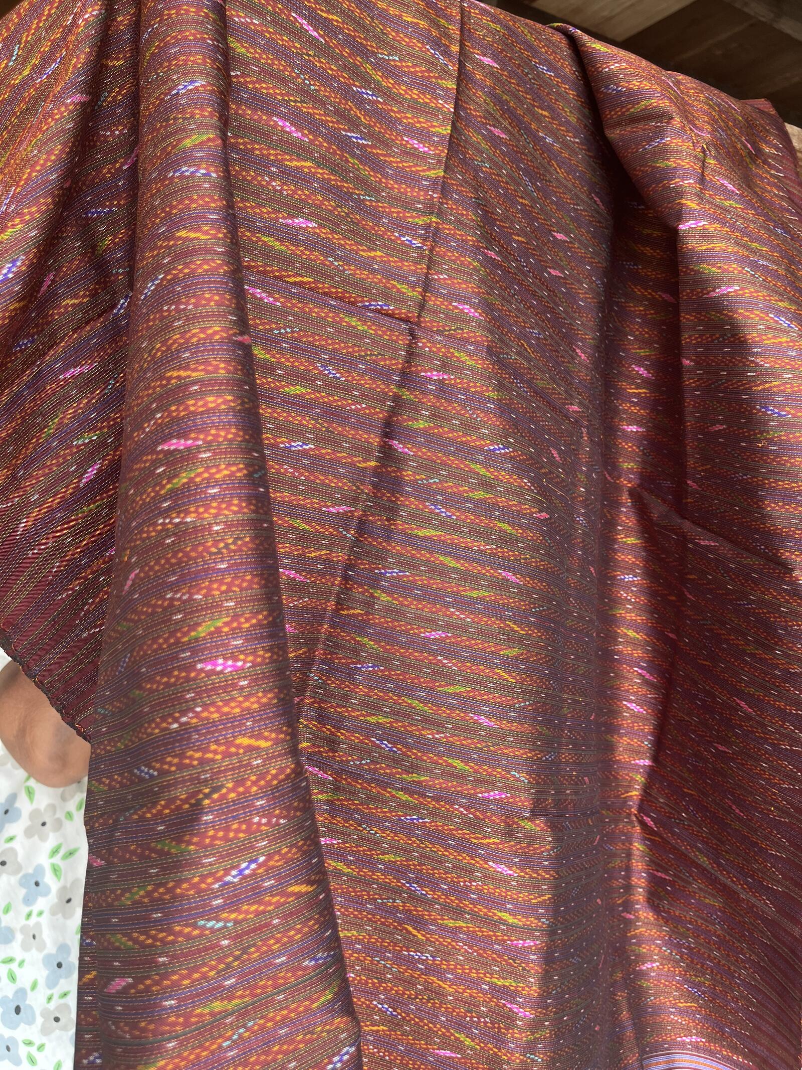 Hol silk in rust and mulberry gathered into loose folds, the figure running in fine broken bands